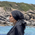 MIMOUNT COUTURE black quick-dry turbante with bow on rocky beach